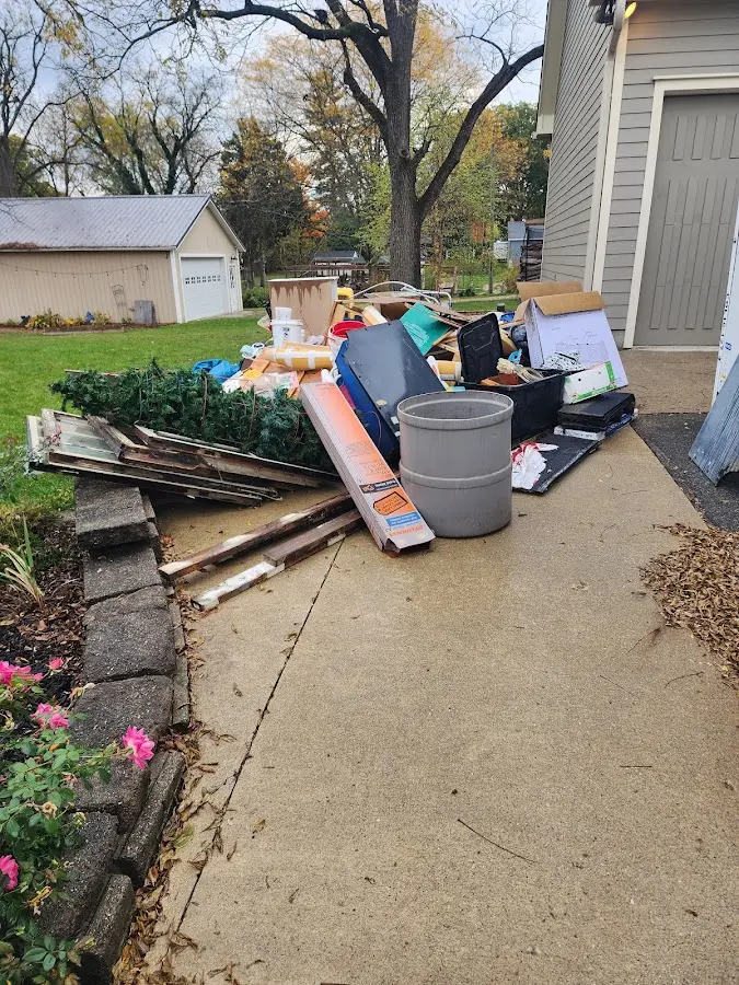 Dumpster being loaded with debris for Roofing Dumpster Rental in Oyster Bay